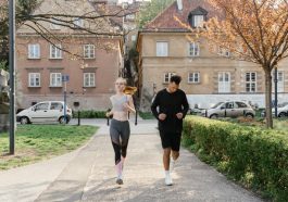 A couple jogging together in an urban park, enjoying outdoor exercise.