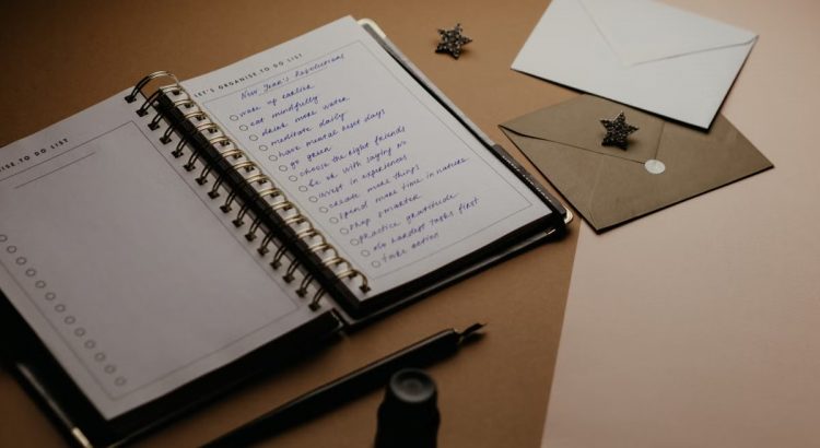 A tidy desk setup featuring a planner, to-do list, envelopes, and a pen.
